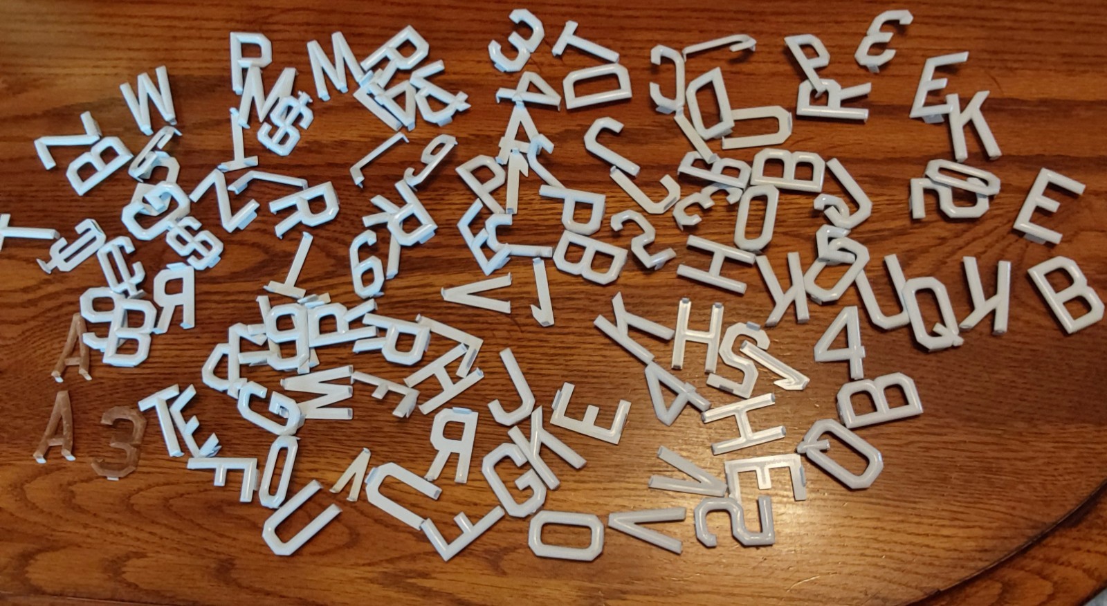 BAG FULL OF WHITE HARD PLASTIC LETTERS & NUMBERS